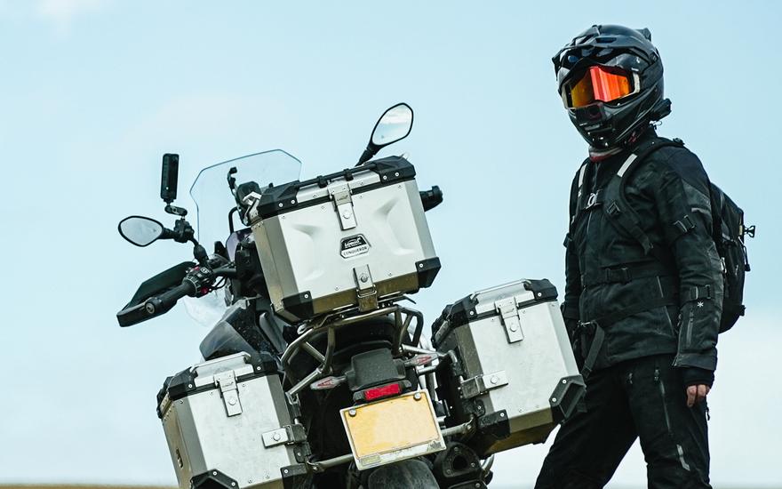 Rider standing beside a bike with luggage