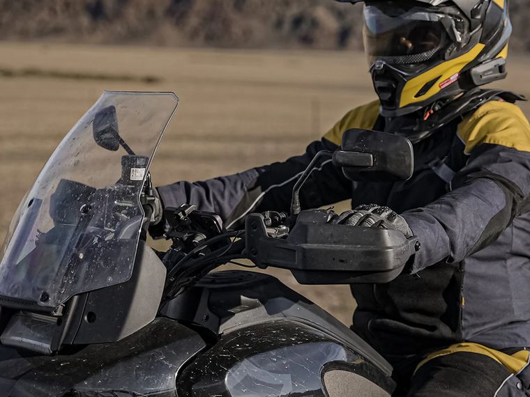 Rider at the controls of an adventure bike